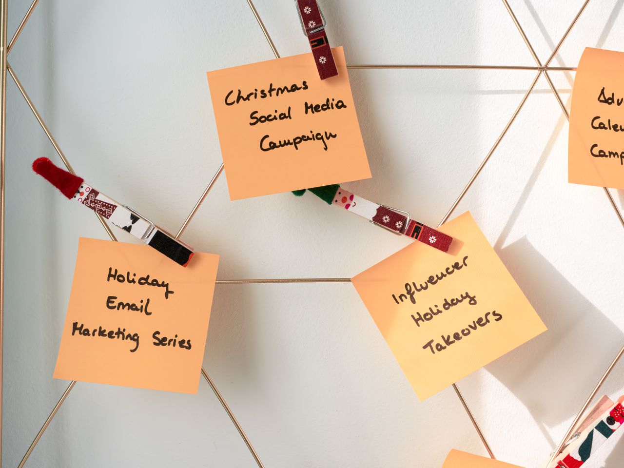 about-us Sticky notes with holiday marketing ideas for Christmas social media and email campaigns.